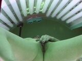 Brunette plays with her pussy in solarium